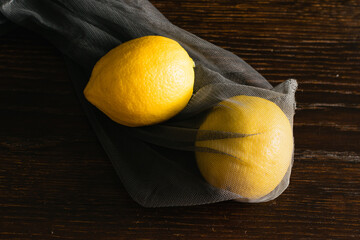 Earth day, recycling and zero waste concept. Lemons in a reusable mesh for fruits and vegetables on...