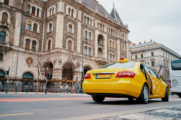 Yellow taxi car on street of Budapest.