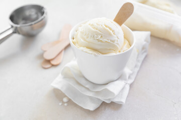Vanilla ice cream in white cup, marble background
