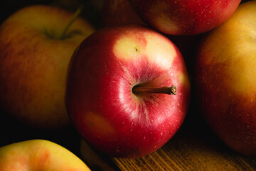 Delicious red apple macro on a wooden cutting board