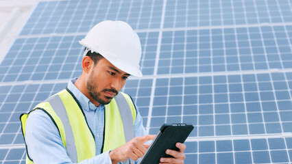 Solar, electricity and construction being done by an engineer while using a tablet for research or...