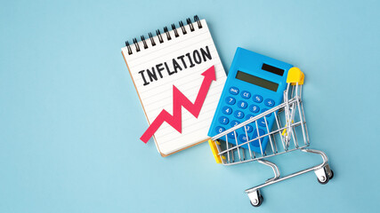 Inflation and consumer price increasing concept, Inflation word and red rising graph on notebook...