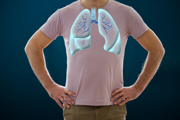 The man standing on a dark background. Picture of a human lungs. Anatomy of healthy respiratory system. Medical concept, internal organs
