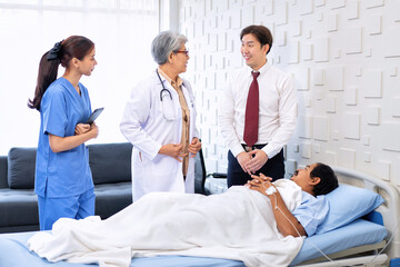 Hospital treatment room relative visit patient lay on bed doctor explain update illness condition