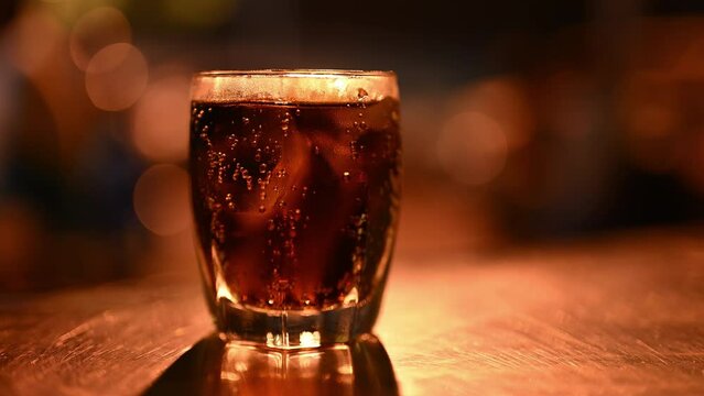 Glass With Cold Drink And Ice Cubes On Table, Frosted Coca Cola In Cup