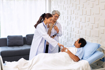 Senior chief physician helping young female doctor device discussing patient diagnosis in hospital.