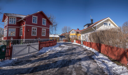 Villas and old wood family houses in the ness Kronudden at the archipelago town Vaxholm, melting...