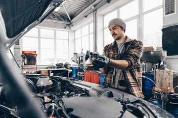 Mechanic examining car in auto car repair service center