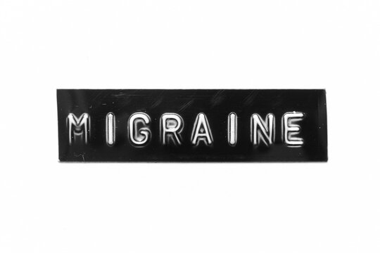Black color banner that have embossed letter with word migraine on white paper background