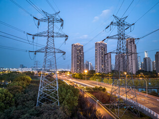 high-voltage power lines. high voltage electric transmission tower at night - 589186718