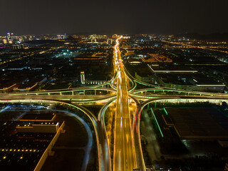 Aerial drone slow shutter night shot of urban elevated toll ring road junction and interchange...