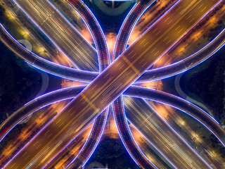 Aerial drone slow shutter night shot of urban elevated toll ring road junction and interchange...