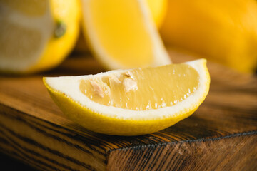 Lemon slices on a wooden cutting board, lemon macro. Juicy tropical fruit on a dark background
