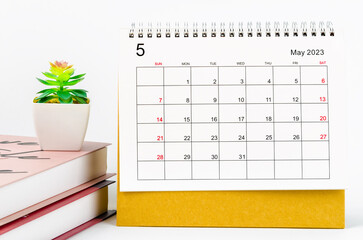 The May 2023 Monthly desk calendar for 2023 year with the books on white background.