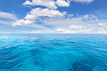 The Beautiful vibrant blue ocean and cloudy on blue sky.