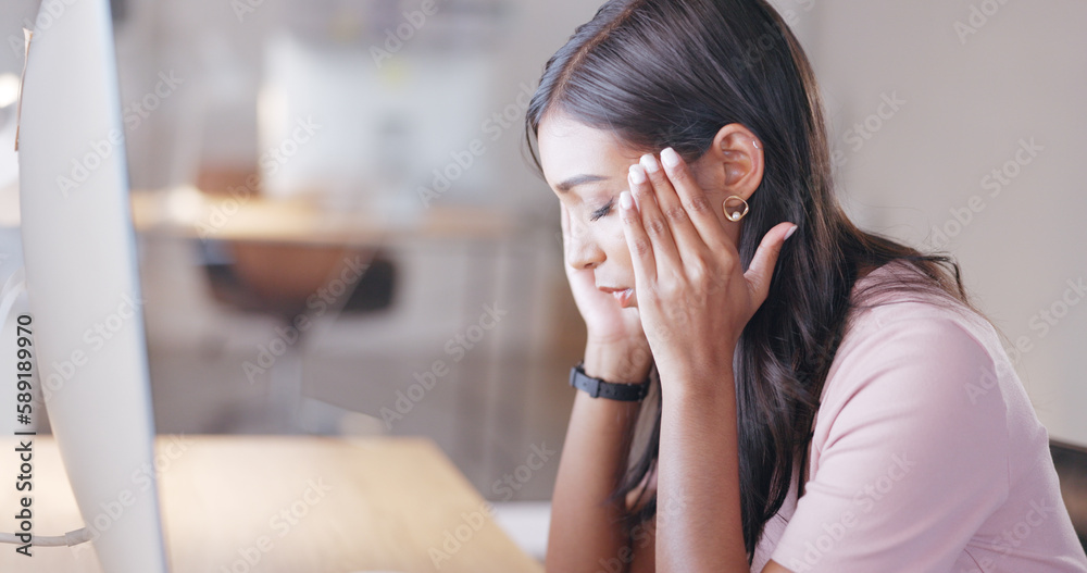 Aufkleber woman suffering from a headache or migraine while working on desktop computer in an office at work. 