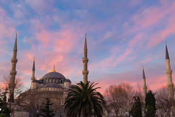 Blue Mosque or Sultanahmet Mosque at sunrise with pink and orange clouds