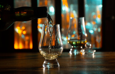 Pouring in tulip-shaped tasting glass Scotch single malt or blended whisky