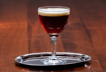 Glass of Belgian abbey brown beer in bar