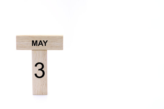 May 3 displayed wooden letter blocks on white background with space for print. Concept for calendar, reminder, date. 