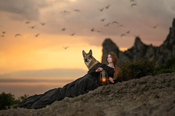 Girl in a black dress with a train with a wolf on the seashore - obrazy, fototapety, plakaty