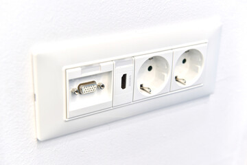 Detail view of an electrical outlet with hdmi connection mounted in interior of  house on wall. House electronics tools and accessories.Selective focus.
