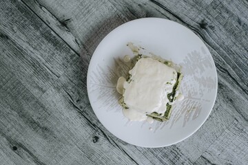 Flat lay shot of a Japanese Matcha Cake and Creamy Custard on a wooden table