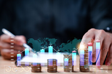businessman carefully monitored statistics of his earnings, value of his investments, stacked coins...