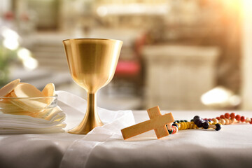 Chalice and consecrated host on table at the altar