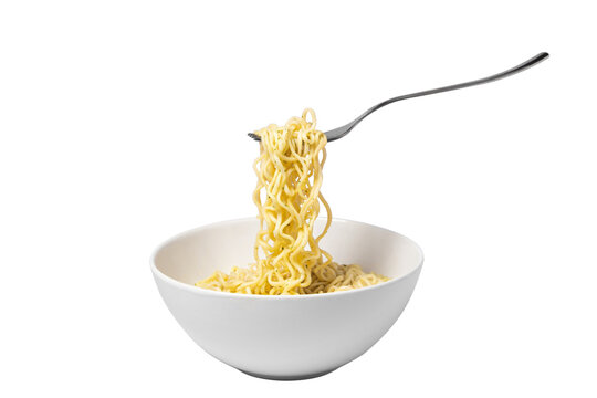 Plate with cooked noodles. The fork takes the noodles. Instant noodles