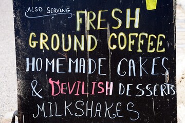 Chalkboard advertising coffee, milkshakes and cakes along the promenade, Lyme Regis, Dorset, UK, Europe