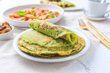 Savory wild garlic pancakes with tomato salad