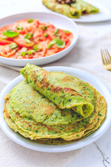 Savory wild garlic pancakes with tomato salad