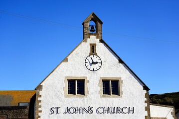 View of St John’s church clock and bell tower in the old town, West Bay, Dorset, UK, Europe