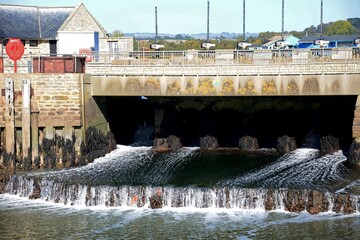 View of the sluice gate in the harbour at low tide, West Bay, Dorset, UK, Europe.