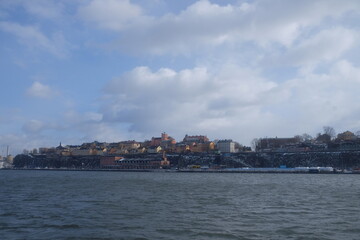 Fototapeta na wymiar Stockholm colourful buildings next to the sea in sunshine 