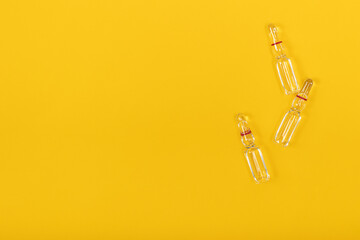 Medicine capsules on a yellow background.