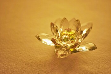 Crystal lotus flower on a brown table, copy space