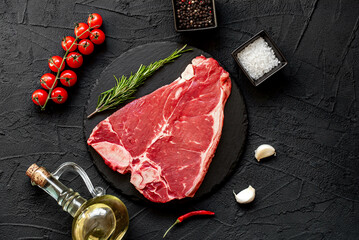 raw T-bone steak on stone background