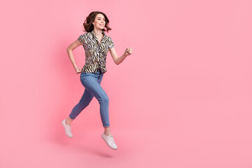 Full body profile portrait of excited carefree lady jump hurry run empty space isolated on pink color background