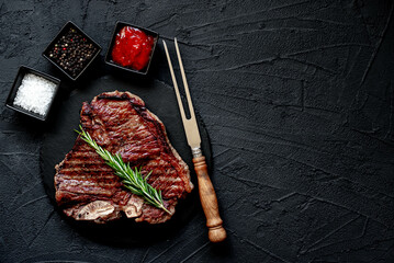 grilled T-bone steak on stone background with copy space for your text