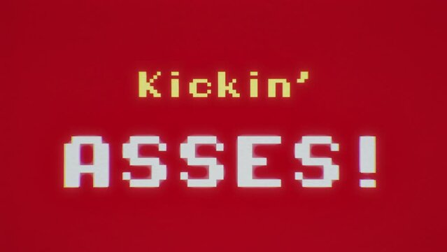 Analog VHS tape capture: 8-bit clean style videogame screen animation, with the text message Kickin' asses. Red background, yellow and white characters.
