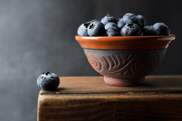 Blueberry in a cup on a black background is the concept for any kind of diet and healthy eating. Closeup, copy space for text