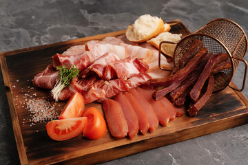 Meat set on a wooden board. Different types of meat, snack for beer