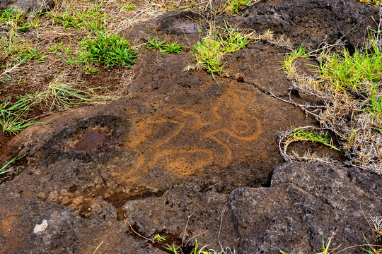 Petroglyph of birdman carved on the lava rock at the restored ceremonial site of Ahu Tongariki on Easter Island (Rapa Nui), Chile.