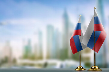 Fototapeta premium Small flags of the Slovenia on an abstract blurry background