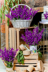 Birthday decoration with lavender flowers on wooden boxes and sweet cake behind