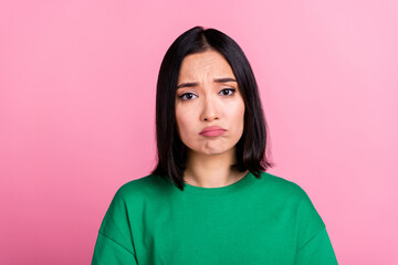 Portrait of unhappy sad woman straight hairstyle oversize t-shirt pouted lips looks disappointed isolated on pink color background