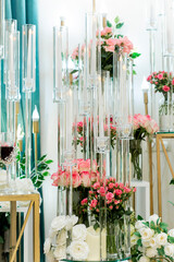 Luxurious wedding decoration with glasses and artificial roses