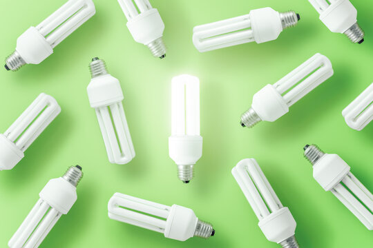 Collection of various light bulbs on green background